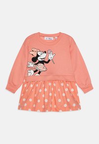 Coral sweatshirt dress featuring a black and white Minnie Mouse graphic, with a polka dot skirt in peach and white. Soft fabric with ribbed cuffs.
