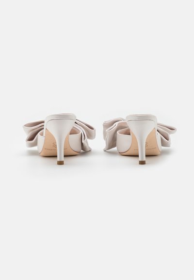 White satin high-heeled shoes with a bow detail at the back, featuring a slender heel and smooth texture. Minimalist design, elegant shape.