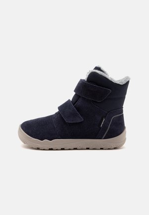 Child's dark blue winter boot with two Velcro straps, light gray sole, and soft white fur lining visible at the top.