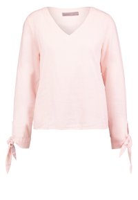 Haut à manches longues rose clair avec col en V et détails noués aux poignets. Fabriqué en tissu côtelé, il présente une coupe décontractée et un design minimaliste.