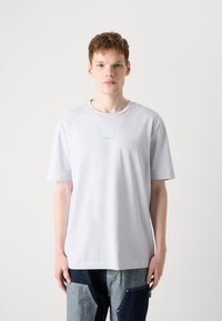 Light gray short-sleeve t-shirt featuring a round neckline and subtle "BOSS" logo in a slightly darker shade. Soft, smooth fabric.