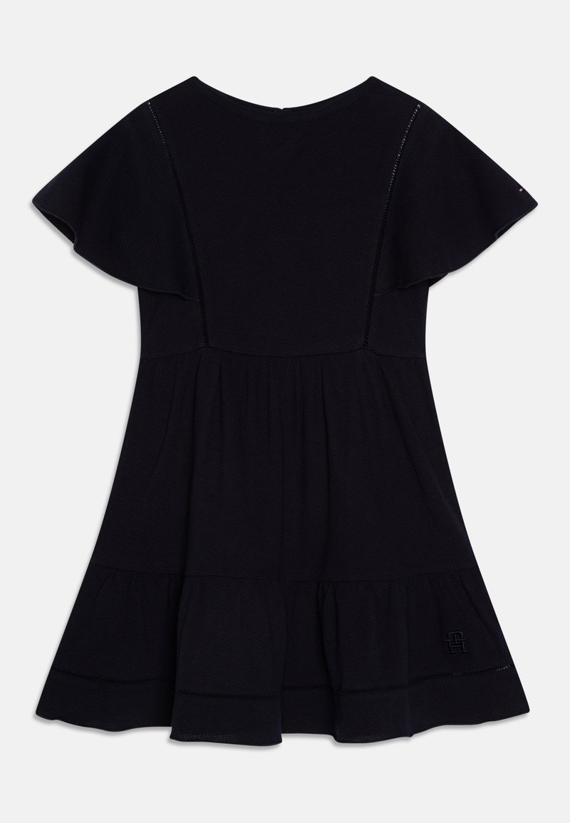 Black dress with short ruffled sleeves, round neckline, and a flared skirt. Made of textured fabric with subtle stitching details.