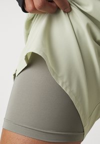 Nike Performance CHALLENGER SHORT - Sports shorts - olive aura/dark stucco/black/silver