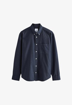 Tumed sinine nööpide jaotuse särk puuvillast, millel on terav krae, pikad varrukad, rinnanipp ja valged nööbid.