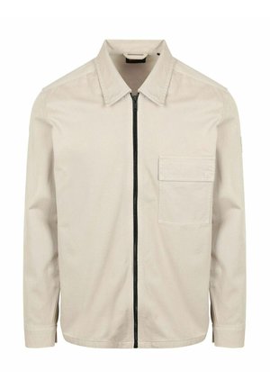 Beige overhemd met lange mouwen, een puntige kraag, een zwarte rits aan de voorkant en een enkele borstzak aan de linkerkant.