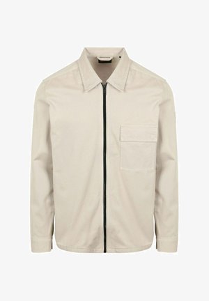 Beiges Langarmhemd mit spitzem Kragen, schwarzem Frontreißverschluss und einer einzelnen Brusttasche auf der linken Seite.