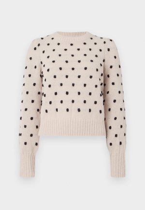 Pull léger beige avec des pois noirs, col rond côtelé et poignets, texture douce, coupe courte et manches longues.