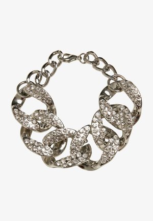 Bracelet en chaîne argentée avec des maillons entrelacés ornés de rhinestones clairs scintillants, créant une surface texturée et réfléchissante.