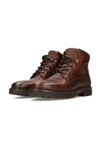 Botas de tobillo de cuero marrón con cierre de cordones, ojales de metal y acentos texturizados. Presenta un collar acolchado y una suela de goma gruesa.
