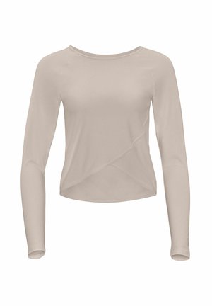 Top beige a maniche lunghe realizzato in tessuto morbido ed elastico. Presenta una scollatura tonda e un taglio asimmetrico con un effetto avvolgente in vita.