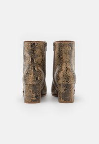 Brown and black snake-print ankle boots with a low block heel, featuring a zipper closure at the back and a textured leather finish.