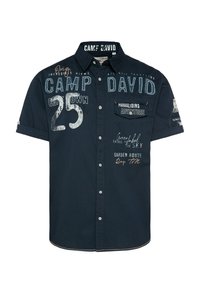 Navy short-sleeve shirt with button closure, featuring various embroidered graphics and text in light colors, including “CAMP DAVID” and “PARAGLIDING ADVENTURE.”