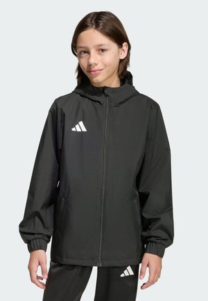 Veste noire légère avec fermeture éclair à l'avant, capuche et poignets élastiques. Présente un logo Adidas blanc sur la poitrine et un pantalon assorti. Texture lisse.