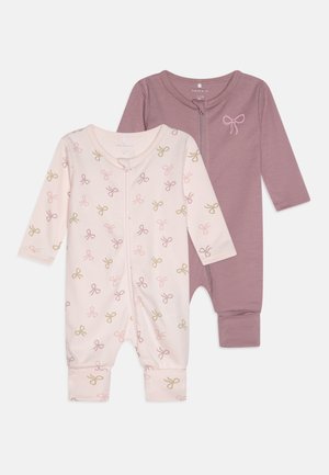 Two baby bodysuits: one in light pink with a bow print, the other in solid mauve. Both have long sleeves and are made of soft fabric.
