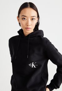Calvin Klein Jeans OFF PLACED MONOLOGO HOODIE  - Felpa - black