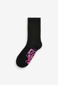 Chaussette en coton noir présentant un motif abstrait rose avec des cercles et des formes près de la cheville, avec une texture lisse et un design de longueur moyenne.
