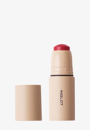 Tube beige du bâton de maquillage Inglot avec produit rouge exposé et capuchon beige retiré, placé à côté sur fond blanc.
