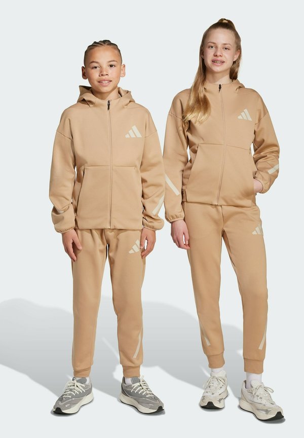 JUNIOR - Tracksuit bottoms - warm sandstone beige