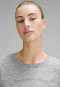 Grijze T-shirt met een ronde halslijn en geribbelde afwerking, met een gladde textuur en een subtiel gemêleerd patroon.