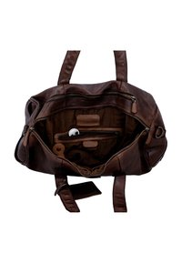 Brown leather handbag open to show interior with zippered pockets, a set of keys, and a small round white object inside.