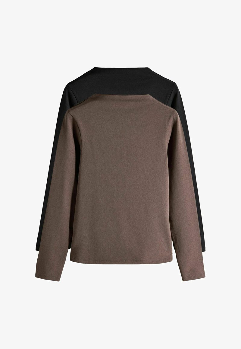 Twee lange mouwen shirts met ronde hals, één bruin voor een zwarte gelegd, plat neergelegd met de achterkant naar boven.