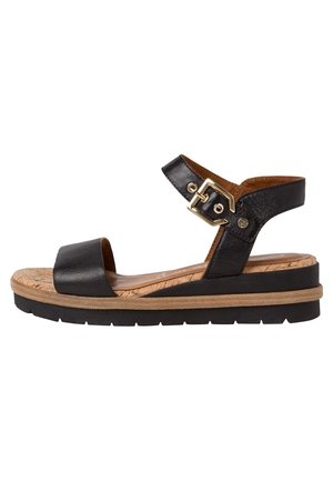 Black leather sandal with adjustable buckle, cork-like midsole, and rubber outsole. Open toe and ankle strap design for comfort.