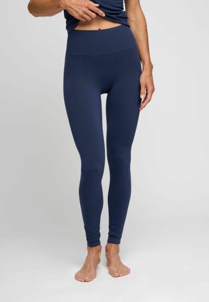 Mørkeblå leggings med høj talje, der har en glat overflade og tætsiddende design, som snævrer ind mod anklen.