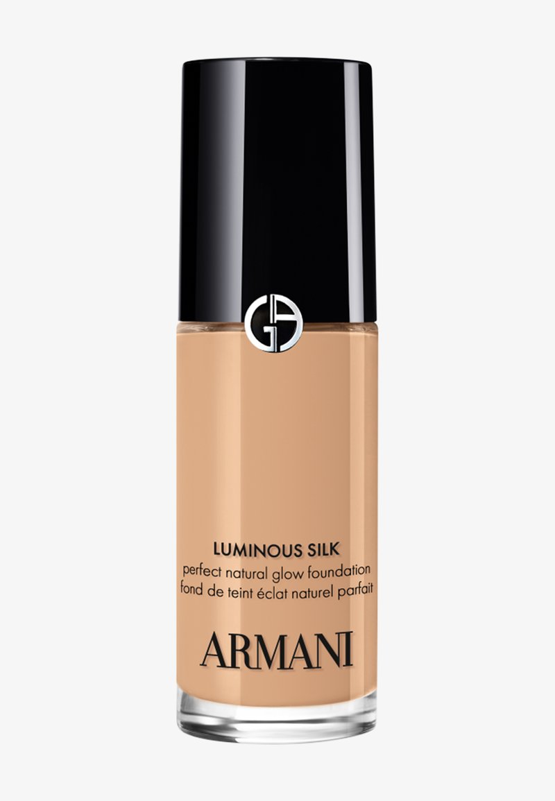 Armani Luminous Silk foundation bottle with black cap, beige liquid inside, and text highlighting natural glow and brand name.