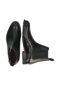 Czarne skórzane botki Chelsea z elastycznymi panelami bocznymi, zaokrąglonym noskiem i teksturowaną gumową podeszwą. Posiadają pętelkę dla łatwego zakładania.