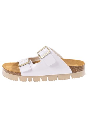 Sandale blanche à glissière avec deux boucles ajustables, semelle en liège et semelle en caoutchouc beige présentant un motif texturé pour une meilleure adhérence.
