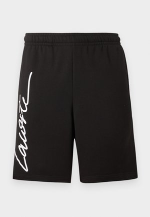 Mustad elastse vöökohaga lühikesed püksid, mille vasaku jala küljele on vertikaalselt trükitud valge kursiiviga "Lacoste" logo.