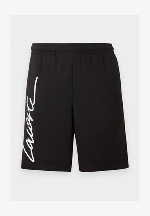 Črni kratki hlače z elastičnim pasom in belim poševnim napisom »Lacoste« na levi nogi.