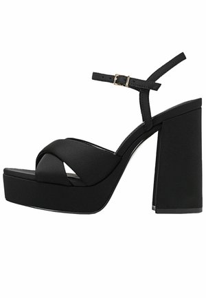 Black platform sandals with a textured finish, featuring a cross-over strap design, adjustable ankle strap, and a chunky block heel.