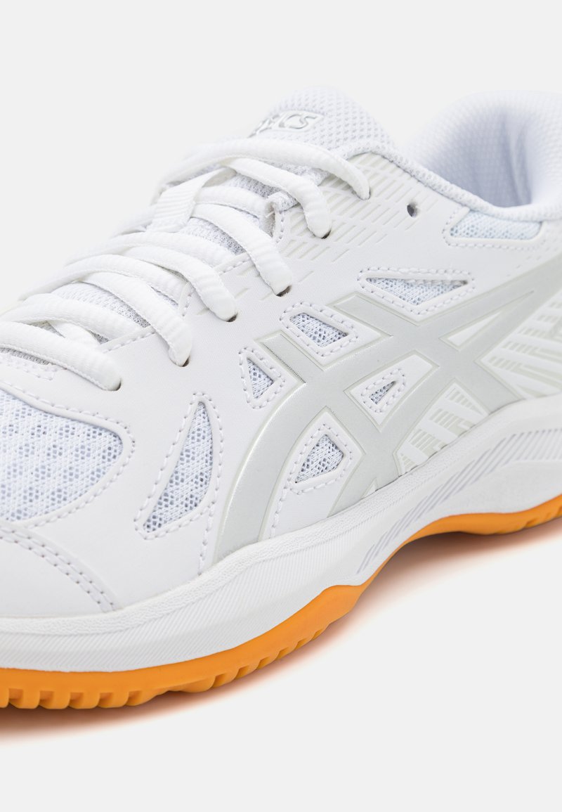 White athletic shoe with mesh panels, light gray accents, and an orange rubber sole. Features a lace-up design and cushioned collar.