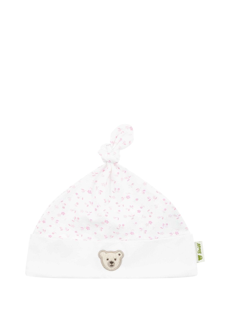 Chapeau pour bébé en coton blanc avec un motif floral rose, un nœud en haut et une application en forme de visage d'ourson sur le revers replié.