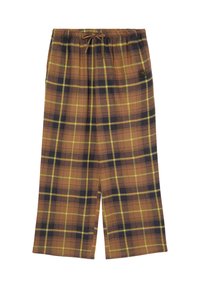 Pantalon large marron à carreaux avec des lignes jaunes et noires, taille élastique avec cordon et petit logo noir sur le côté droit.