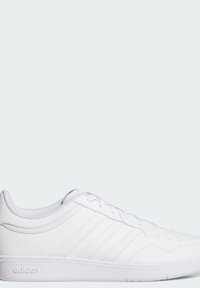 White athletic shoes with synthetic upper, six lace eyelets, textured sole, and three tonal stripes on the side. Minimalist design.
