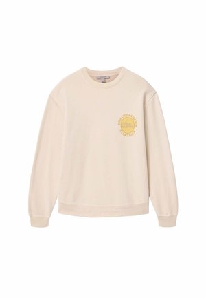 Beige sweatshirt met lange mouwen, ronde hals en een klein geel cirkelvormig logo met tekst op de linkerborst.