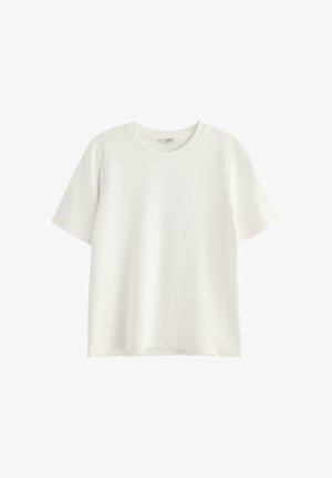 Lyhythihainen valkoinen t-paita, joka on valmistettu pehmeästä puuvillasta. Pyöreä pääntie ja rento istuvuus. Ei näkyviä kuvioita tai grafiikoita.
