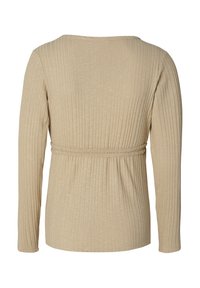 Beige ribbade långärmade topp med en figurnära midja, rundad halsringning och subtil textur. Mjuk tyg, avslappnad design.
