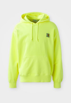 Neon yellow hoodie made of cotton. Features a front pocket, drawstring hood, and a small logo patch on the upper left side. Soft texture.