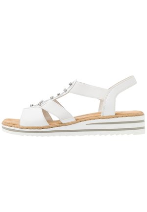 Sandalo bianco open-toe con cinturini elastici, accenti argentati, soletta in sughero imbottita e una suola a zeppa bianca con motivo e strisce grigie.