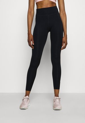 Zwarte high-waisted leggings gemaakt van rekbaar materiaal, met een gladde textuur en een aansluitend ontwerp, voorzien van subtiele zij naden.