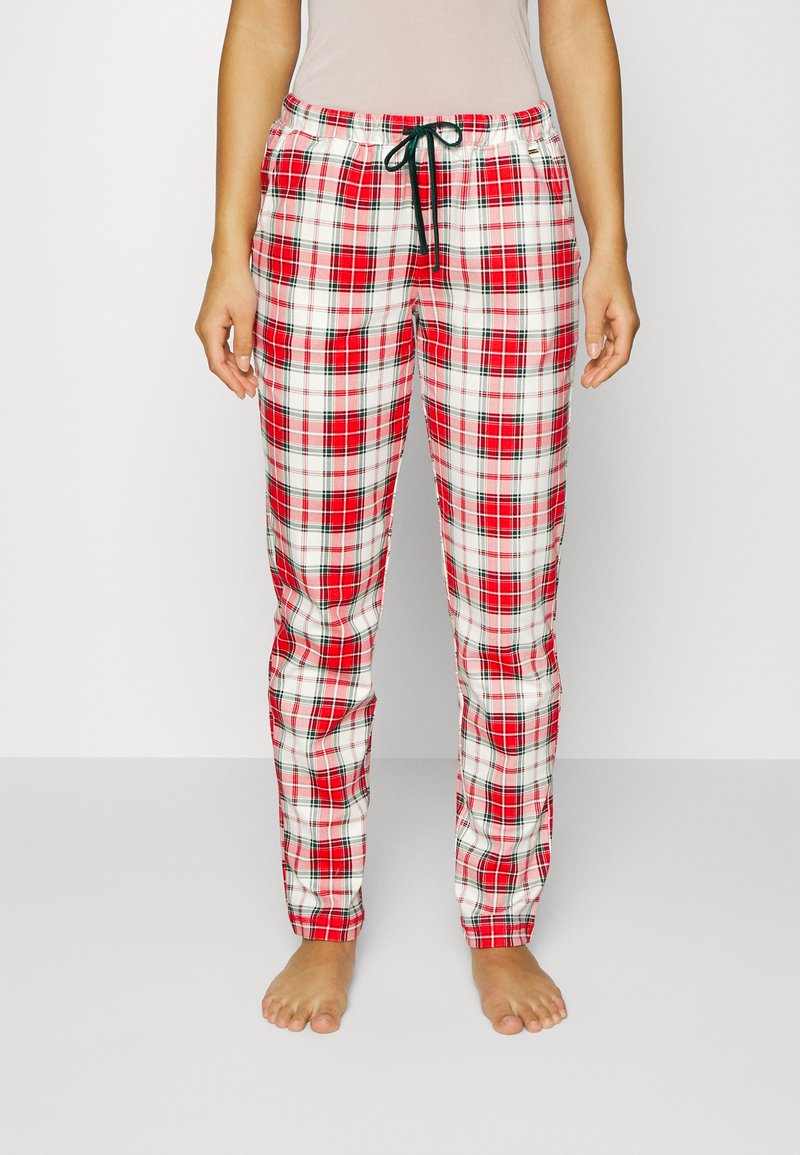 Rode en witte geruite pyjamabroek met een elastische tailleband en trekkoord. Rechte pijpen en gemaakt van een zachte, lichte stof.