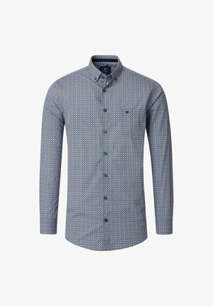 Blå skjorte med knaplukning og geometrisk mønster i gul og hvid. Har krave, lange ærmer og knaplukning.