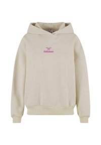 Beige huppari, jossa on etutasku, nyöritettävä hupun ja ribatut hihansuut. Rinnassa on pinkki brodeerattu logo. Pehmeää puuvillakangasta.
