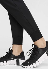 Nike Performance JOGGER - Pantalones deportivos - black white