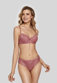 Lace lingerie set in rose color; underwire bra with scalloped edges and a bow detail, paired with matching lace briefs featuring zigzag patterns.