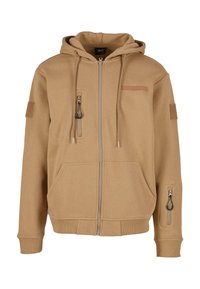 Svetlohnedá mikina na zips s kapucňou, dvoma prednými vreckami a bočným vreckom; má textúrovanú látku a dekoratívne ťaháky na zips.