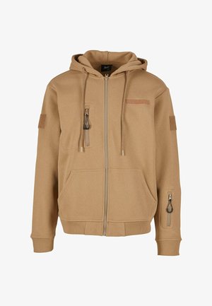 Tan zip-up hoodie with a hood, two front pockets, and a side pocket; features a textured fabric and decorative zipper pulls.